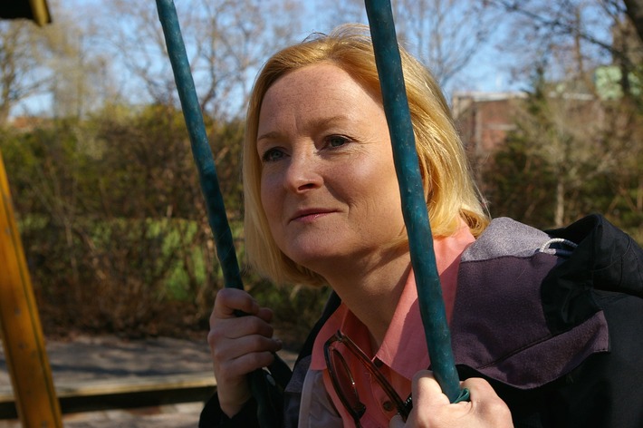 A middle-aged woman sits on a swing, recalling the hardships she's overcome. (image courtesy of Pixabay).